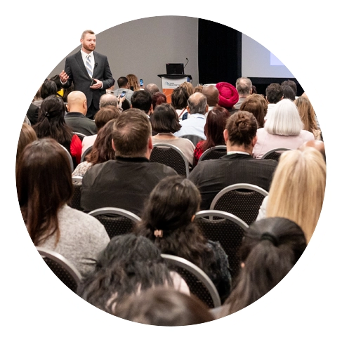 Speaker presenting in front of a crowd